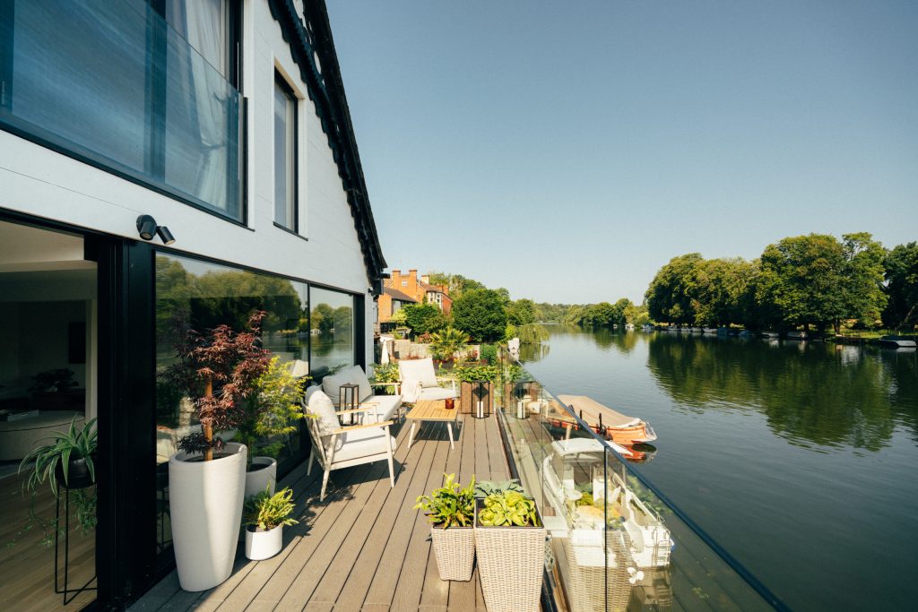 Riverside terrace with exterior wall lighting at the Pangbourne property
